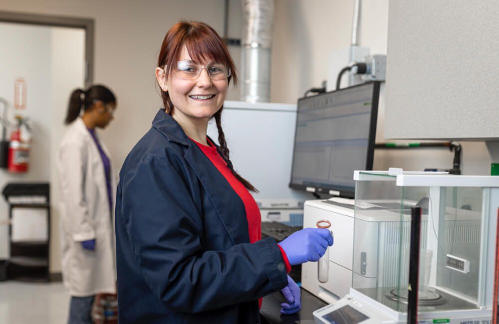 A lab worker holding a beaker