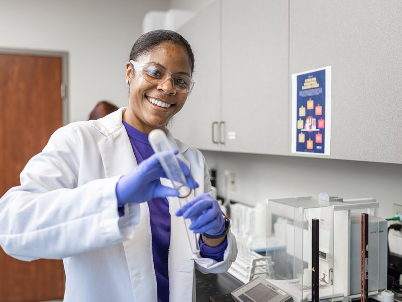 Lab worker using a beaker